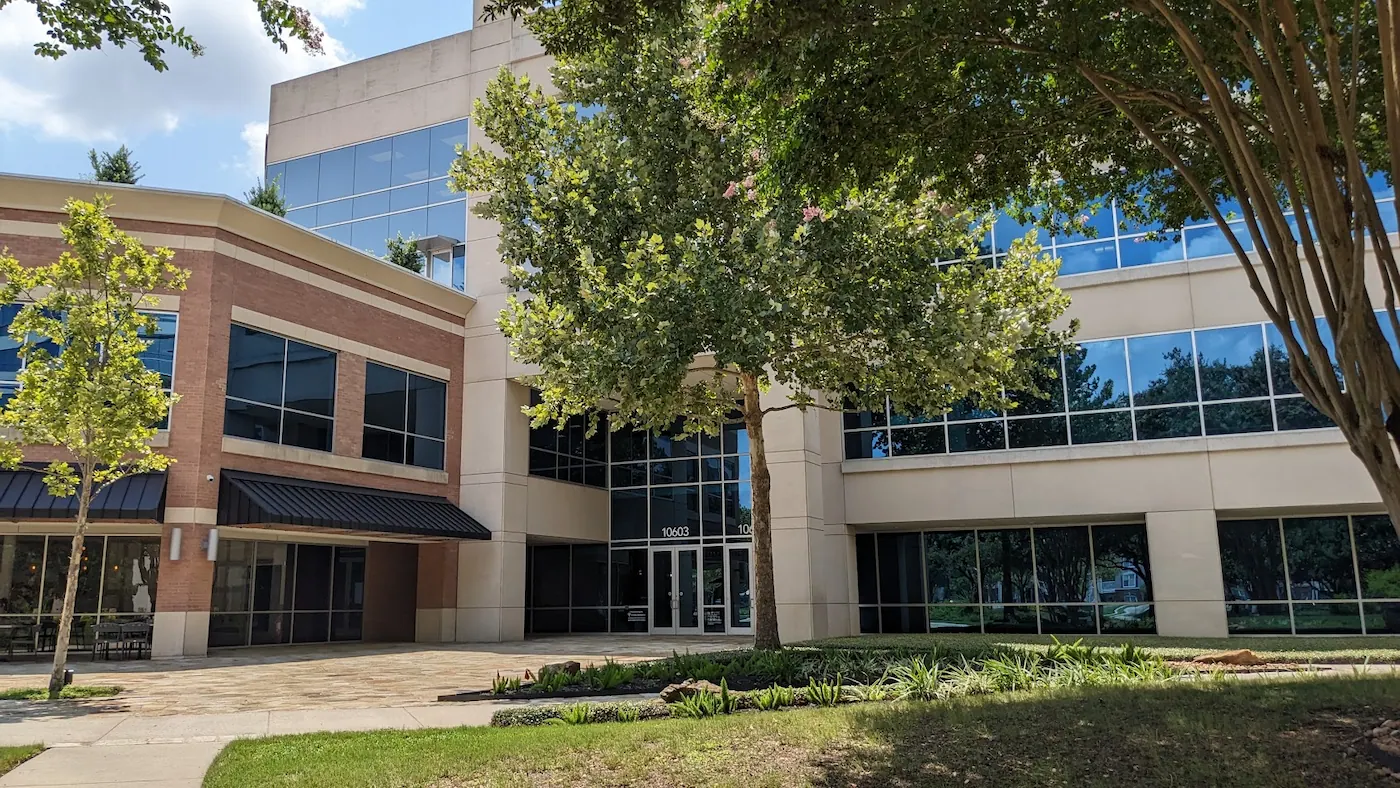 Modern office building with large windows and trees