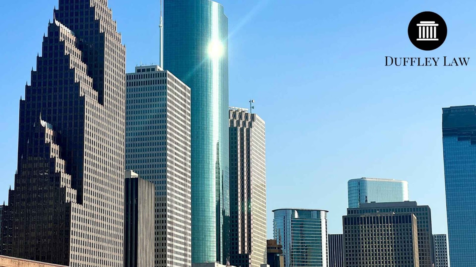 Modern Houston skyscrapers with Duffley Law logo