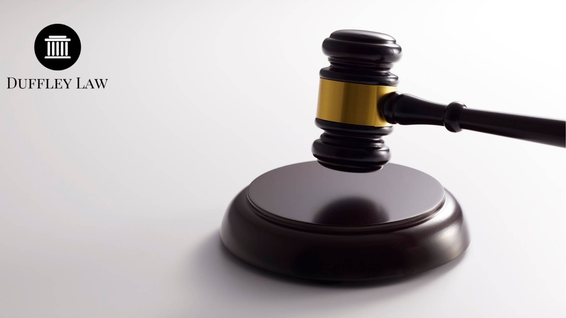 Gavel on table, Duffley Law logo visible