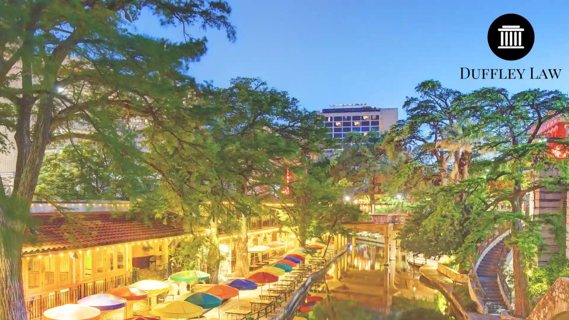Colorful riverside cafes and trees at sunset at san antonio