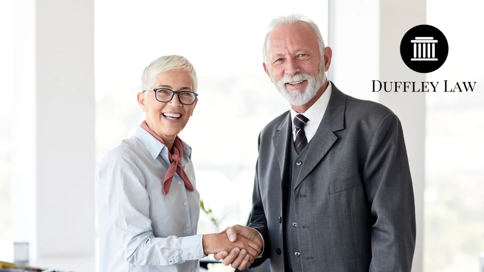 Two professionals shaking hands at Duffley Law.