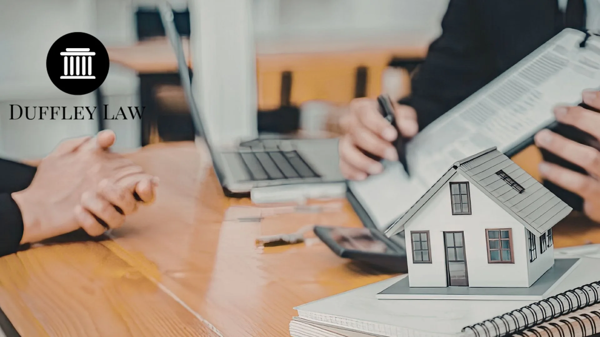 Real estate law consultation with house model