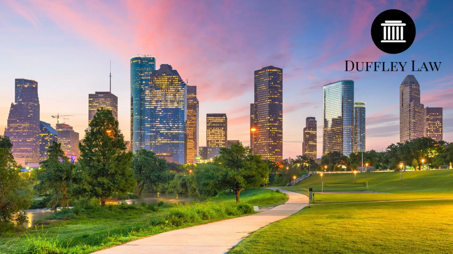 Houston skyline at sunset above park and trail