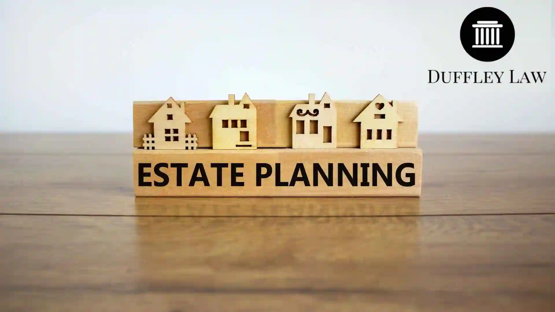 Wooden houses atop estate planning block with Duffley Law logo